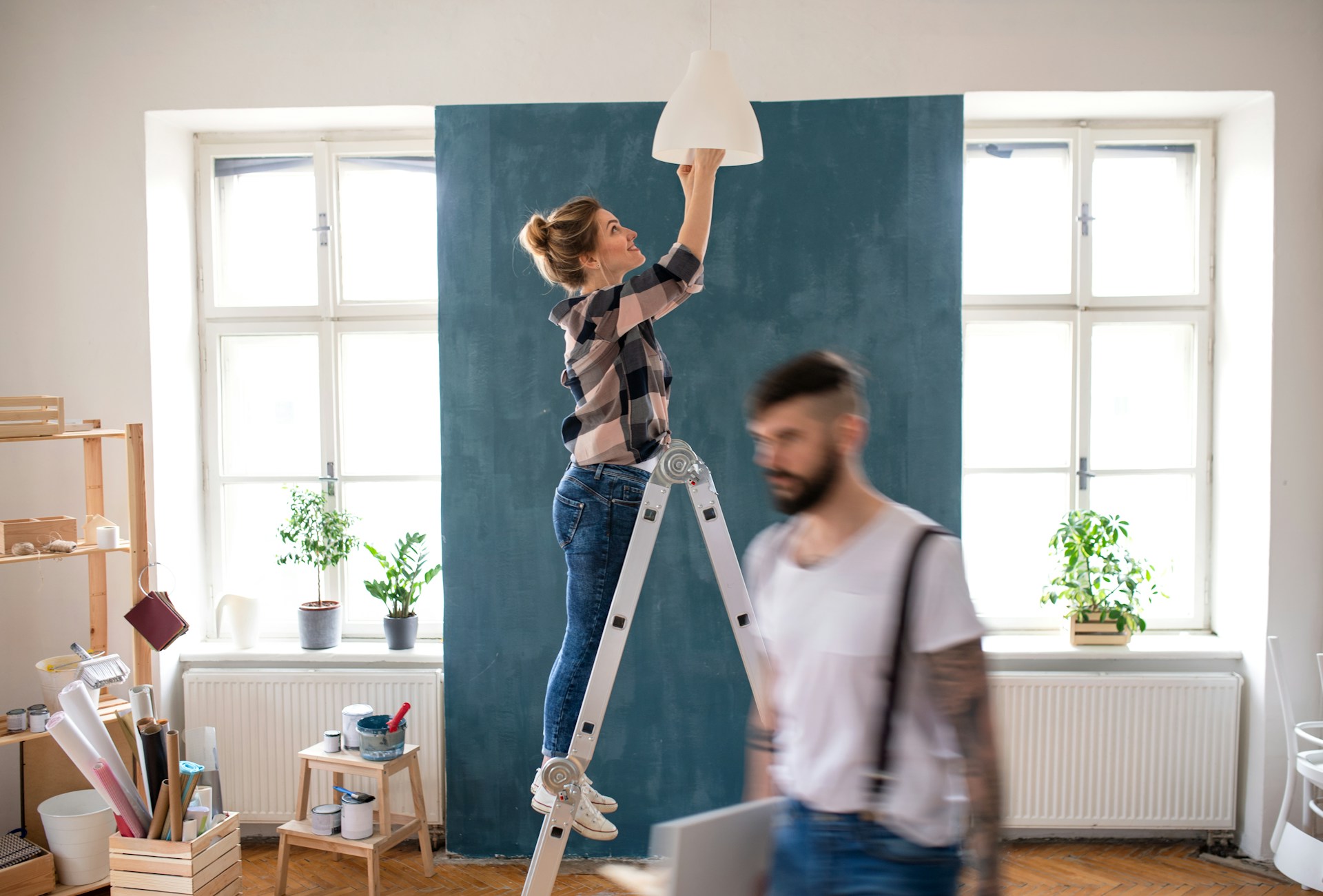 A young couple doing home renovations, representing home flipping taxes in British Columbia