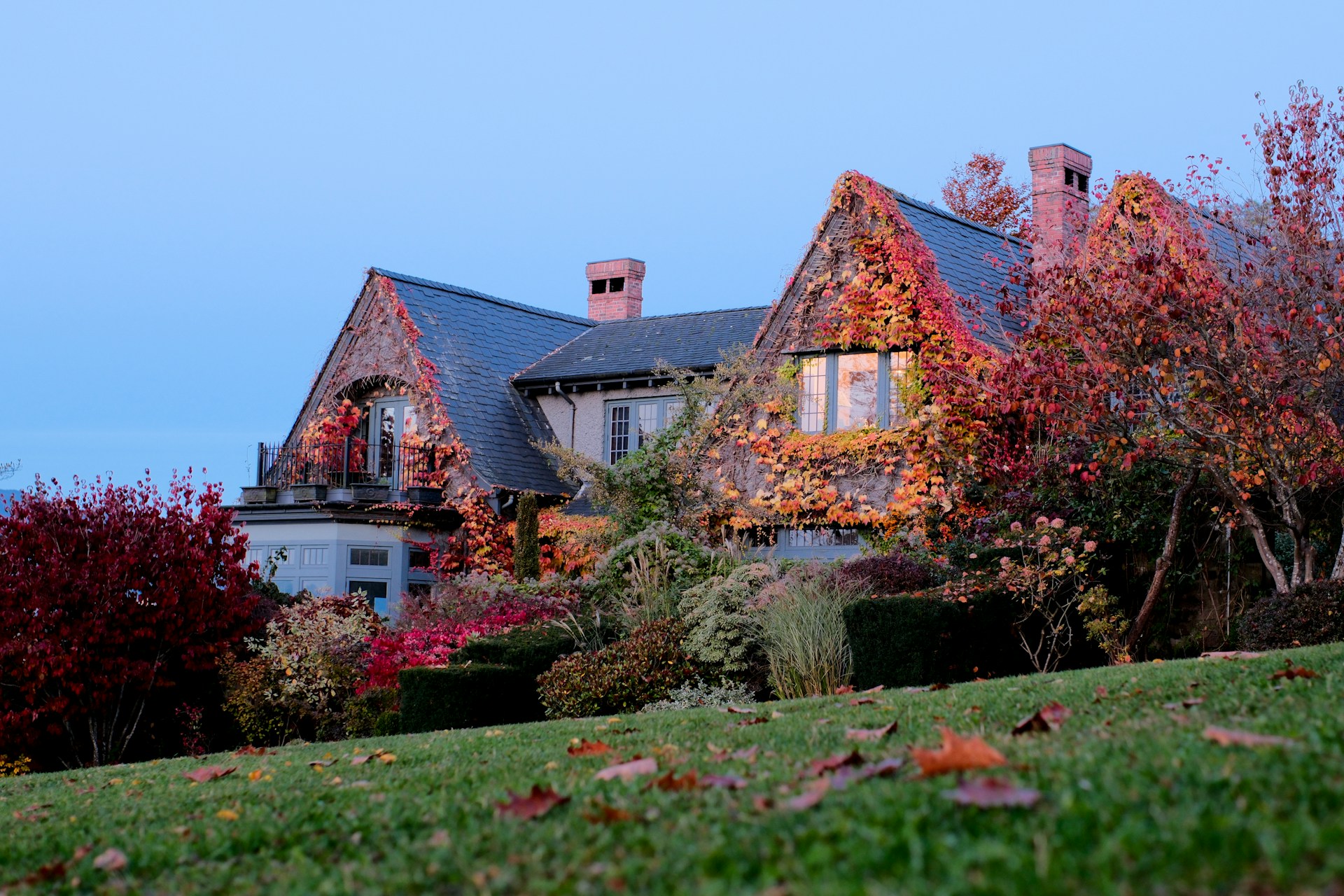 Large Tudor-style manor house in British Columbia covered in Autumn foliage, representing co-ownership property disputes and the right of first refusal.